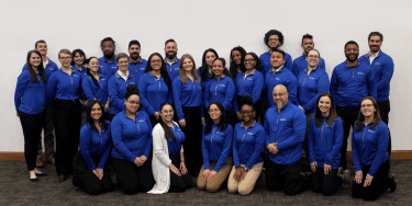 Teams of counselors in blue shirts