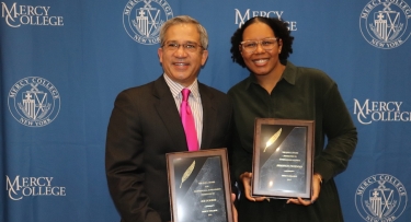 Man and woman with awards