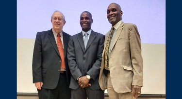 Mercy College Staff pose with Phillip Grant