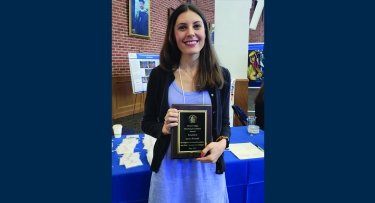 Professor holding award