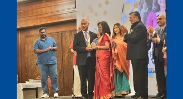 Photo of Renu receiving award.