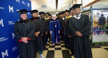 Mercy University President Susan L. Parish processes with graduates at Sin Sing Correctional Facilty