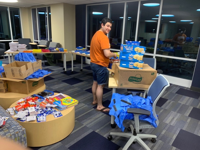 Mercy Student preparing backpack giveaway