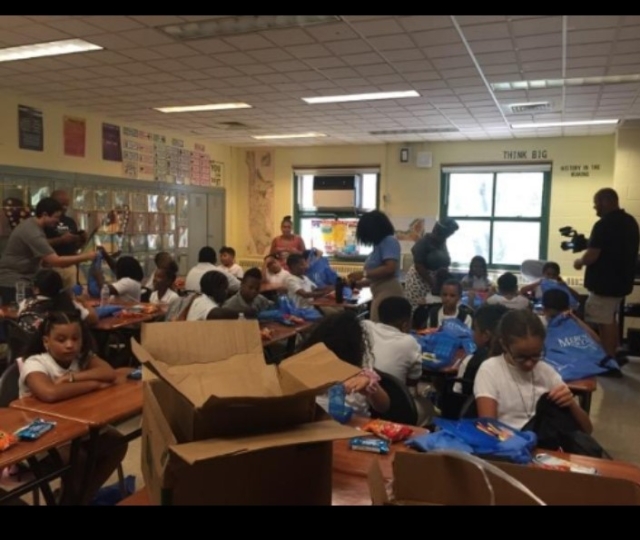 Kids opening the backpacks Mercy Students prepared 