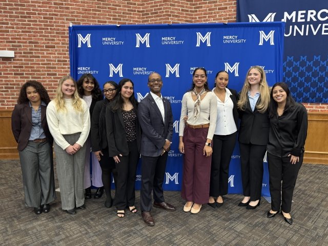 Mercy University students pose with Lauder Institute Alumni panelist at Black History Month fireside chat